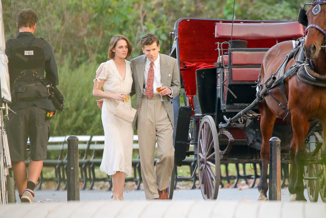 Kristen Stewart and Jesse Eisenberg are seen holding a glass of wine after taking a ride in a horse carriage in Central Park while they're filming scenes for The Untitled Woody Allen Project in New York City